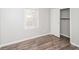 Bright bedroom featuring wood-look flooring, a window, and a closet for storage at 3406 Blackberry Ln, Villa Rica, GA 30180