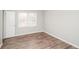 Cozy bedroom featuring wood-look flooring, a window, and neutral paint at 3406 Blackberry Ln, Villa Rica, GA 30180