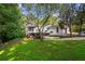 Spacious backyard with mature trees and a charming two-story home at 4648 Danna Dr, Austell, GA 30106