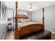 Comfortable bedroom with a four-poster bed, bench, and hardwood floors at 4648 Danna Dr, Austell, GA 30106