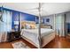 Stylish bedroom with blue accent wall, four-poster bed, and hardwood floors at 4648 Danna Dr, Austell, GA 30106