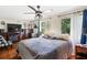 Spacious bedroom with a large bed, windows, and entertainment center with fireplace at 4648 Danna Dr, Austell, GA 30106