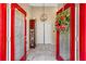 Inviting foyer with tile flooring, bright red door frames and an elegant light fixture at 4648 Danna Dr, Austell, GA 30106