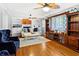 Bright living room featuring hardwood floors, built-in shelving, and a large entertainment center at 4648 Danna Dr, Austell, GA 30106