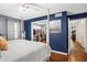 Bedroom showcasing a walk-in closet and ensuite access, featuring blue walls and hardwood floors at 4648 Danna Dr, Austell, GA 30106