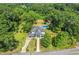An aerial shot shows the lovely home with a pool and barn surrounded by lush trees at 205 Cobb St, Palmetto, GA 30268