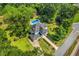 Aerial view showcases a house, pool, and barn, all surrounded by lush greenery and trees at 205 Cobb St, Palmetto, GA 30268