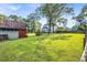 Expansive grassy backyard with a barn on the left and the house in the background at 205 Cobb St, Palmetto, GA 30268