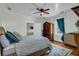 Comfortable bedroom featuring wood floors, a ceiling fan, and cozy decor at 205 Cobb St, Palmetto, GA 30268