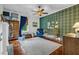 Bedroom with a gold crib, hardwood floors, plaid wallpaper, and natural light at 205 Cobb St, Palmetto, GA 30268