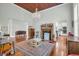 Bonus room featuring hardwood floors, a fireplace, and a view into the kitchen at 205 Cobb St, Palmetto, GA 30268
