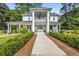 Stately two-story home featuring grand columns, a covered porch, and mature landscaping along the walkway at 205 Cobb St, Palmetto, GA 30268