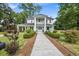 Charming two-story home boasts a welcoming covered porch and neatly manicured landscaping, creating a picturesque curb appeal at 205 Cobb St, Palmetto, GA 30268