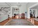 Elegant foyer with hardwood floors, chandelier, staircase, and open archway to the rest of the home at 205 Cobb St, Palmetto, GA 30268