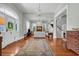 Open foyer boasts hardwood floors, a chandelier, an arched doorway, and a staircase at 205 Cobb St, Palmetto, GA 30268