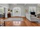 Bright living room featuring hardwood floors, chandelier, white trim, and ample natural light at 205 Cobb St, Palmetto, GA 30268