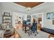 Well-lit office showcasing hardwood floors, a beamed ceiling, and views into the rest of the home at 205 Cobb St, Palmetto, GA 30268