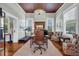 Inviting office space with a cozy fireplace, a beamed ceiling, and natural light from windows at 205 Cobb St, Palmetto, GA 30268