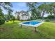 Inviting in-ground swimming pool surrounded by green grass, perfect for relaxation and recreation at 205 Cobb St, Palmetto, GA 30268