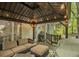 The covered back deck features comfortable outdoor seating and a grill, perfect for entertaining at 4971 Fairhaven Ne Way, Roswell, GA 30075