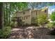 The backyard boasts a covered deck with string lights, steps to a lush garden, and a sprawling lawn at 4971 Fairhaven Ne Way, Roswell, GA 30075