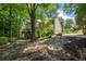 The backyard features a fire pit, mature trees, and deck, creating an inviting outdoor space at 4971 Fairhaven Ne Way, Roswell, GA 30075