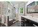 This modern bathroom features a tiled shower with glass door and a sleek vanity with a large mirror at 4971 Fairhaven Ne Way, Roswell, GA 30075