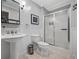 Updated bathroom features a pedestal sink and a tiled shower with glass doors at 4971 Fairhaven Ne Way, Roswell, GA 30075