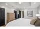 Bedroom features a neutral color palette, hardwood floors, recessed lighting, and tall doors at 4971 Fairhaven Ne Way, Roswell, GA 30075