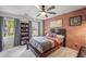 Bedroom featuring a full size bed and a charming brick accent wall at 4971 Fairhaven Ne Way, Roswell, GA 30075