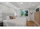 Bedroom features a neutral color palette, hardwood floors, large windows, and a tray ceiling at 4971 Fairhaven Ne Way, Roswell, GA 30075