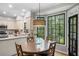 Kitchen dining area featuring a large window with black frames and a view to the backyard at 4971 Fairhaven Ne Way, Roswell, GA 30075