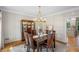 Formal dining room with hardwood floors, crown molding, chandelier and a view into the kitchen at 4971 Fairhaven Ne Way, Roswell, GA 30075