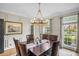 Elegant dining room with hardwood floors, crown molding, chandelier and picture window at 4971 Fairhaven Ne Way, Roswell, GA 30075