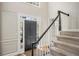 Inviting foyer with staircase, neutral walls, and a view of the front door with sidelights at 4971 Fairhaven Ne Way, Roswell, GA 30075