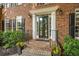 Elegant front entrance features brick steps, black railings, and a glass-paned front door with sidelights at 4971 Fairhaven Ne Way, Roswell, GA 30075