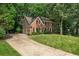 Charming brick residence features a well-manicured lawn, attached garage, and inviting curb appeal at 4971 Fairhaven Ne Way, Roswell, GA 30075