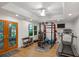 Bright home gym boasts wood floors, ample natural light, and full range of fitness equipment at 4971 Fairhaven Ne Way, Roswell, GA 30075