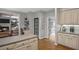 Bright kitchen with light wood floors, cabinets, stainless steel appliances and view to the living room at 4971 Fairhaven Ne Way, Roswell, GA 30075