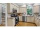 Functional kitchen design with stainless steel appliances and modern fixtures at 4971 Fairhaven Ne Way, Roswell, GA 30075