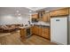This kitchen features hardwood floors, granite countertops, light wood cabinets, and a refrigerator at 4971 Fairhaven Ne Way, Roswell, GA 30075