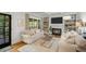 Bright living room featuring a fireplace, built-in shelving, and hardwood floors at 4971 Fairhaven Ne Way, Roswell, GA 30075
