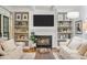 Cozy living room features a fireplace, built-in shelving, and neutral furniture at 4971 Fairhaven Ne Way, Roswell, GA 30075