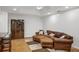 The living room features hardwood floors, recessed lighting, and a comfortable leather couch at 4971 Fairhaven Ne Way, Roswell, GA 30075