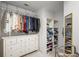 Walk-in closet with an open layout, custom shelving, and a built-in dresser at 4971 Fairhaven Ne Way, Roswell, GA 30075