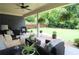 Cozy outdoor living space featuring comfortable furniture and a peaceful view of the lush backyard at 5714 Pickens Garden Ln, Powder Springs, GA 30127