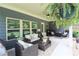 Relaxing covered patio with comfortable seating, ceiling fan, and a view of the private backyard at 5714 Pickens Garden Ln, Powder Springs, GA 30127