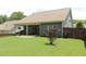 Beautiful backyard with a covered patio and well-maintained lawn, perfect for outdoor entertaining at 5714 Pickens Garden Ln, Powder Springs, GA 30127