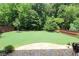Expansive backyard featuring a lush lawn, mature trees, and a privacy fence, creating a serene outdoor oasis at 5714 Pickens Garden Ln, Powder Springs, GA 30127