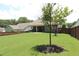 Lush backyard featuring a large lawn and wooden fence at 5714 Pickens Garden Ln, Powder Springs, GA 30127